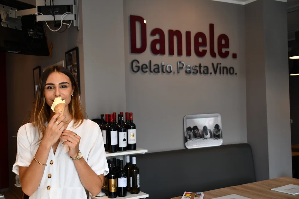 A young woman enjoying gelato in the café